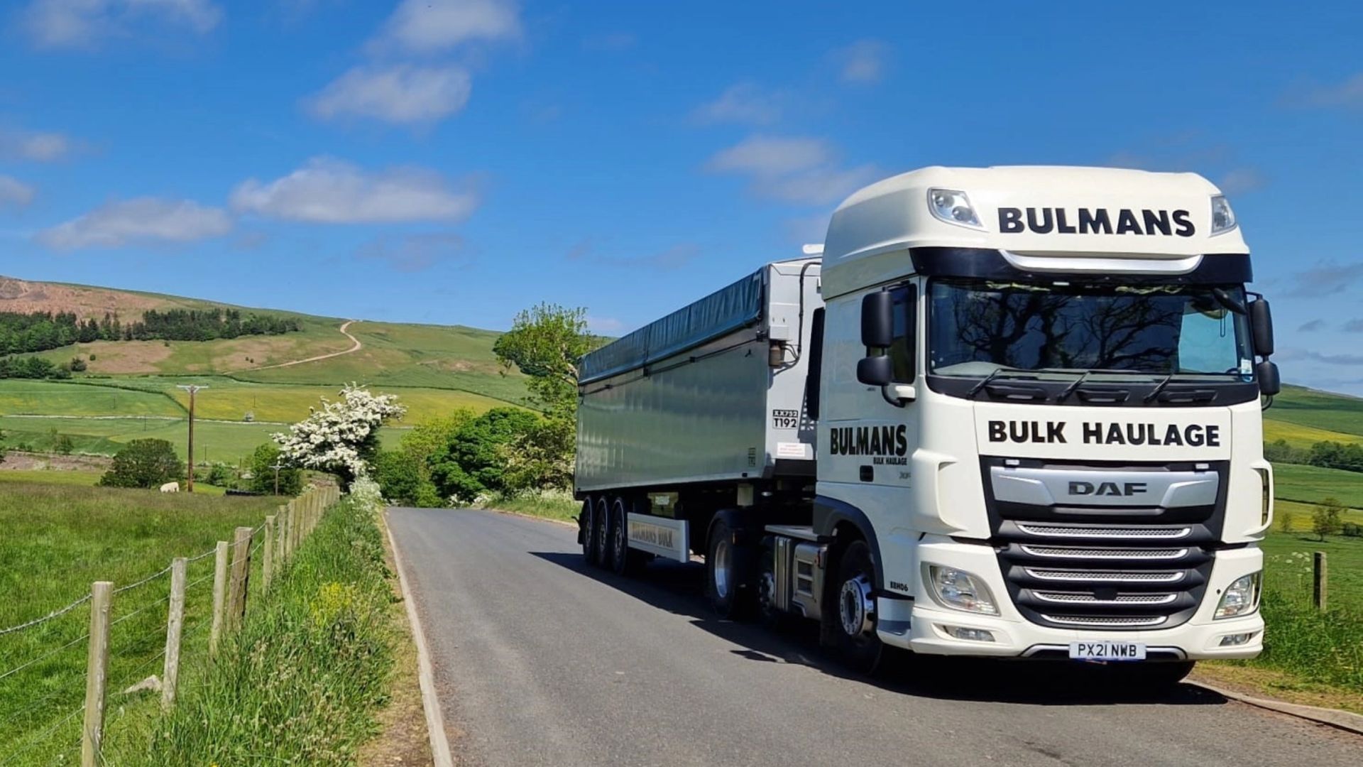 A Bulmans Bulk Haulage DAF Truck driving through the countryside on a sunny day, in the English Lake District.