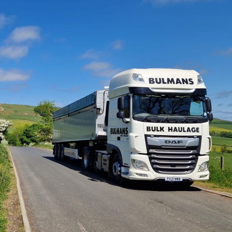 A Bulmans Bulk Haulage DAF Truck driving through the countryside on a sunny day, in the English Lake District.
